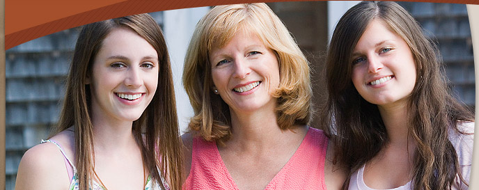 woman and teen girls smiling