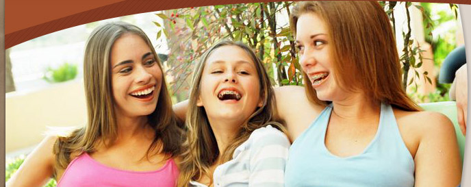 woman and teen girls smiling